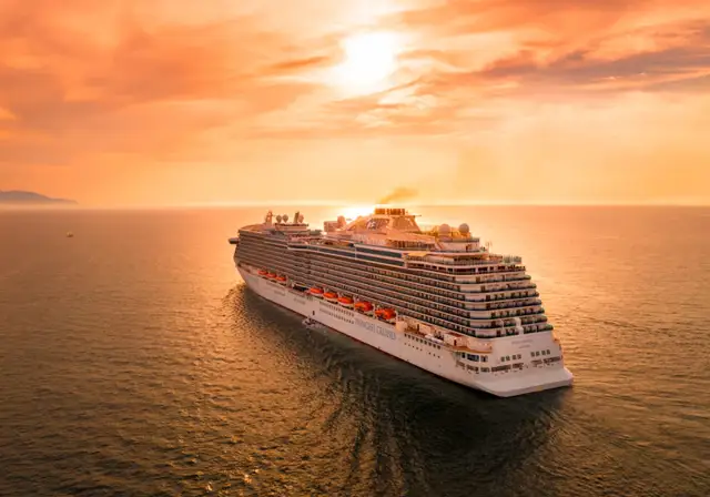 Cruise ship sailing at sunset